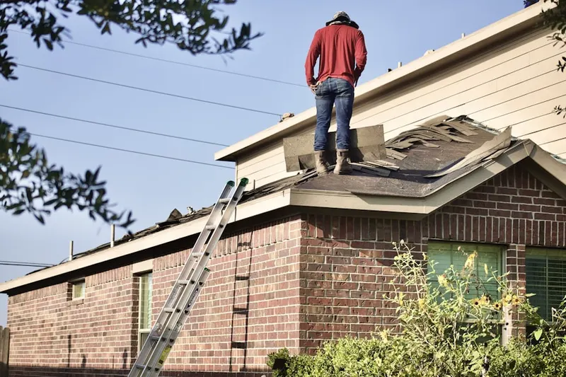 Professional roofer working on a residential roof in Ellis Crossroads